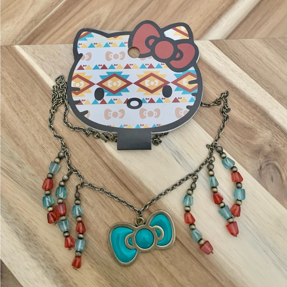 Hello Kitty Loungefly Sanrio golden enameled bow with beaded fringe necklace NWT